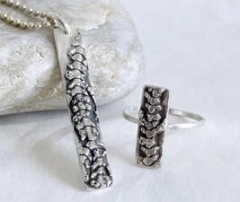 Coralline Algae charm and ring. Molded from algae washed ashore on the California Central Coast. Coralline Algae uses calcium in ocean water to build herself a skeleton.